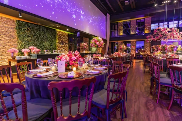 A banquet table dressed with vibrant floral arrangements